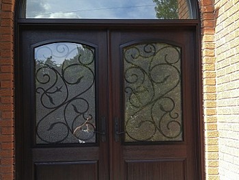 Fiberglass door with privacy glass and Wrought Iron design Exterior View Including massive transom