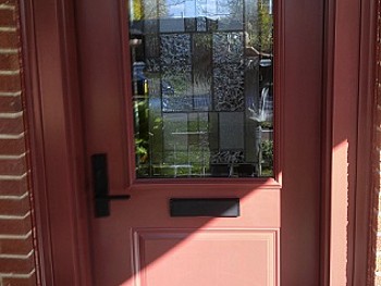 Custom salmon coloured steel door with 1/2 insert