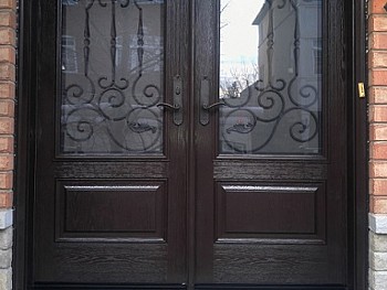 Two panel fiberglass door with wrought Iron 1/2 panels