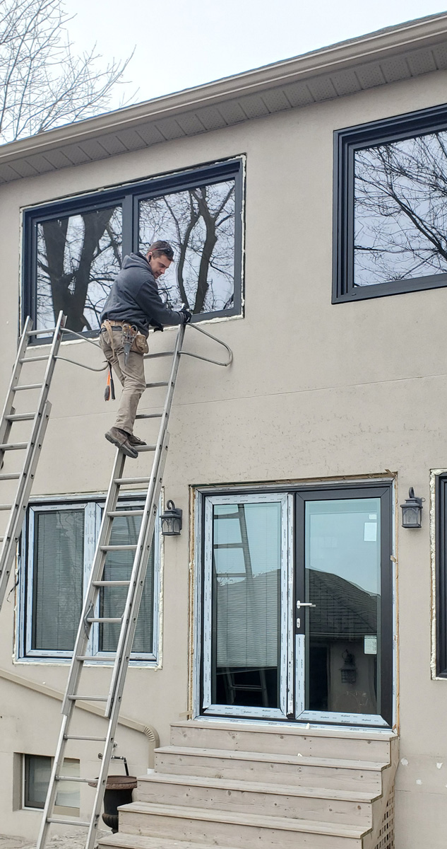 Forhomes installer on the ladder in Etobicoke